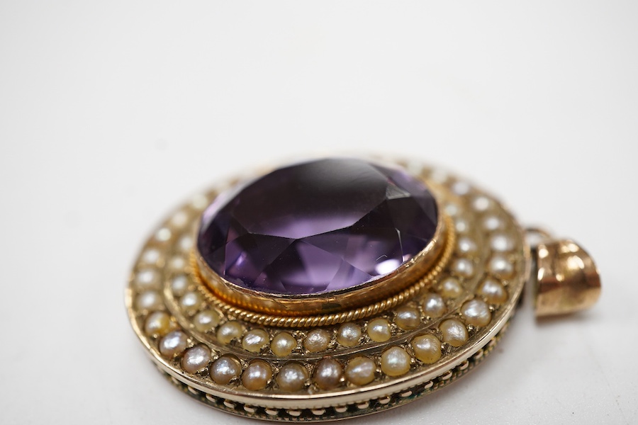 An Edwardian 9ct gold, amethyst and seed pearl cluster set oval pendant, Edwin Alfred Marsh, Birmingham, 1903, overall 35mm.